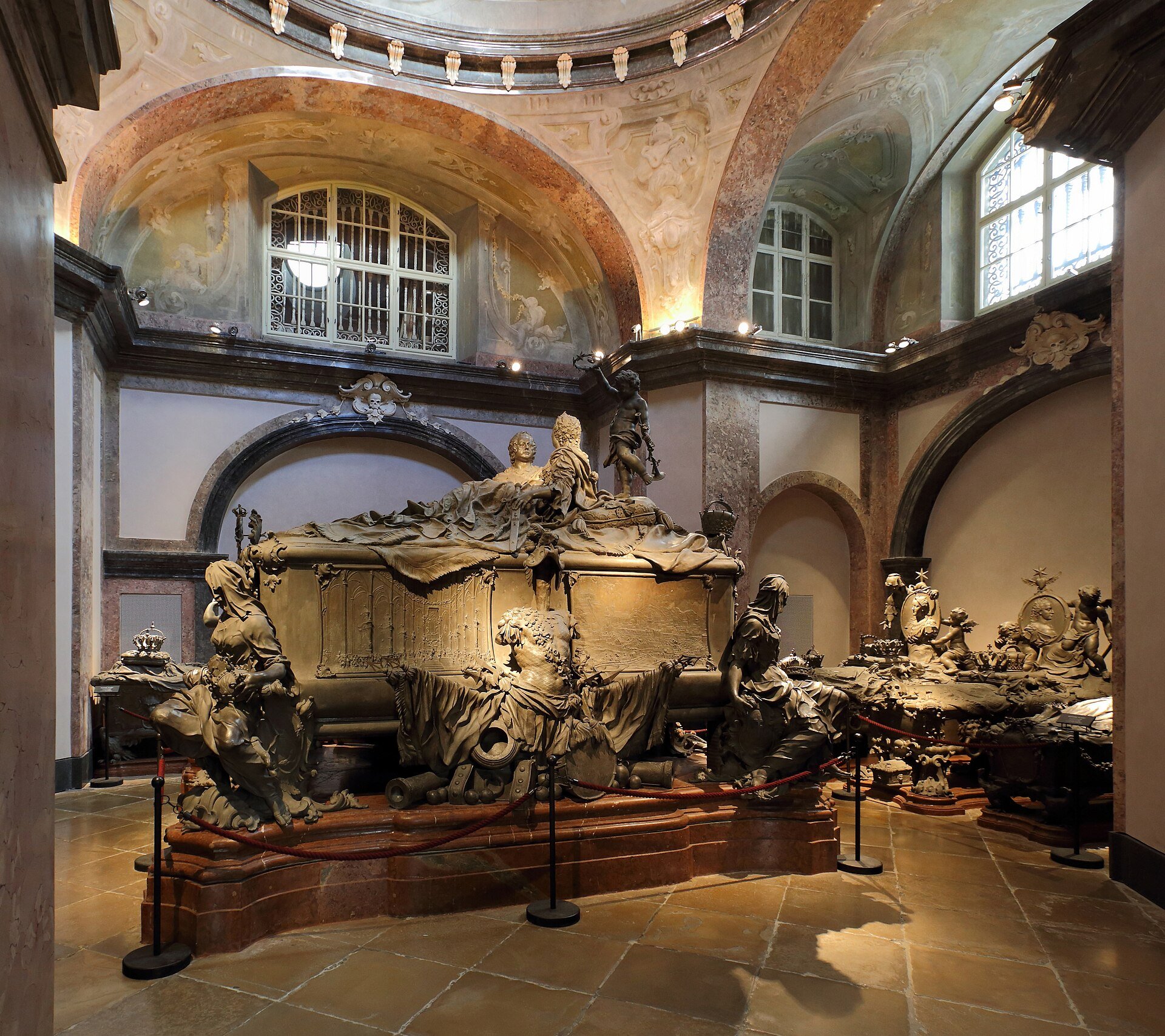 The double sarcophagus of Maria Theresa and Francis I in the Maria Theresa crypt of the Kaisergruft, with rope barriers on a stone floor