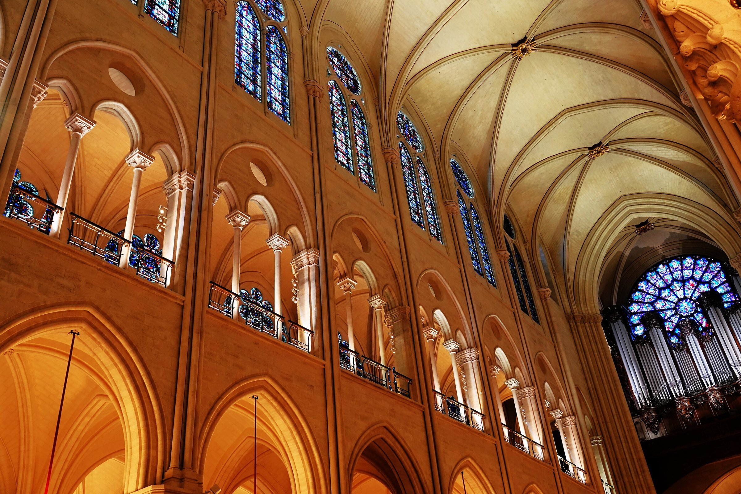 The restored nave of Notre-Dame de Paris looking towards the west portal, with the rose window and the great organ